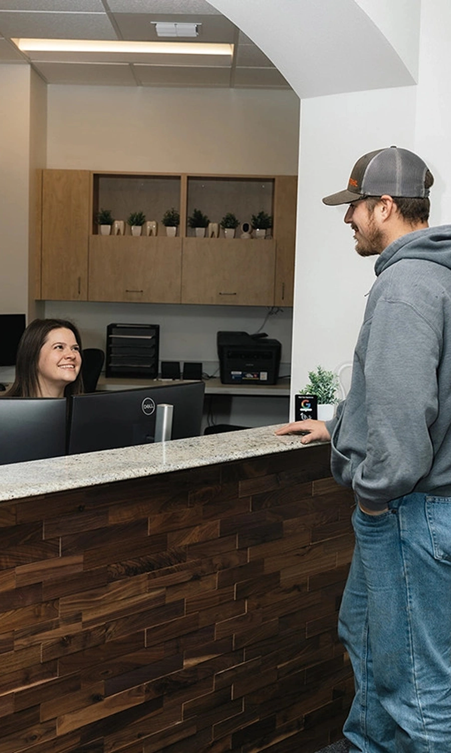 Friendly dental hygienist welcoming new patient at Spokane dentist office
